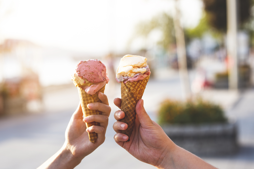 two people holding ice cream cones