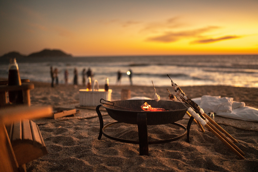 Bonfire with marshmallows at sunset on the beach