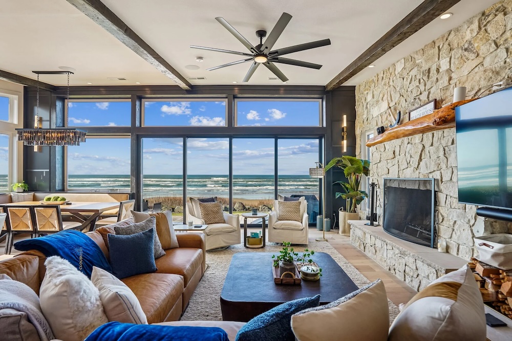 Living room view through large windows overlooking pacific ocean from luxury cannon beach vacation home